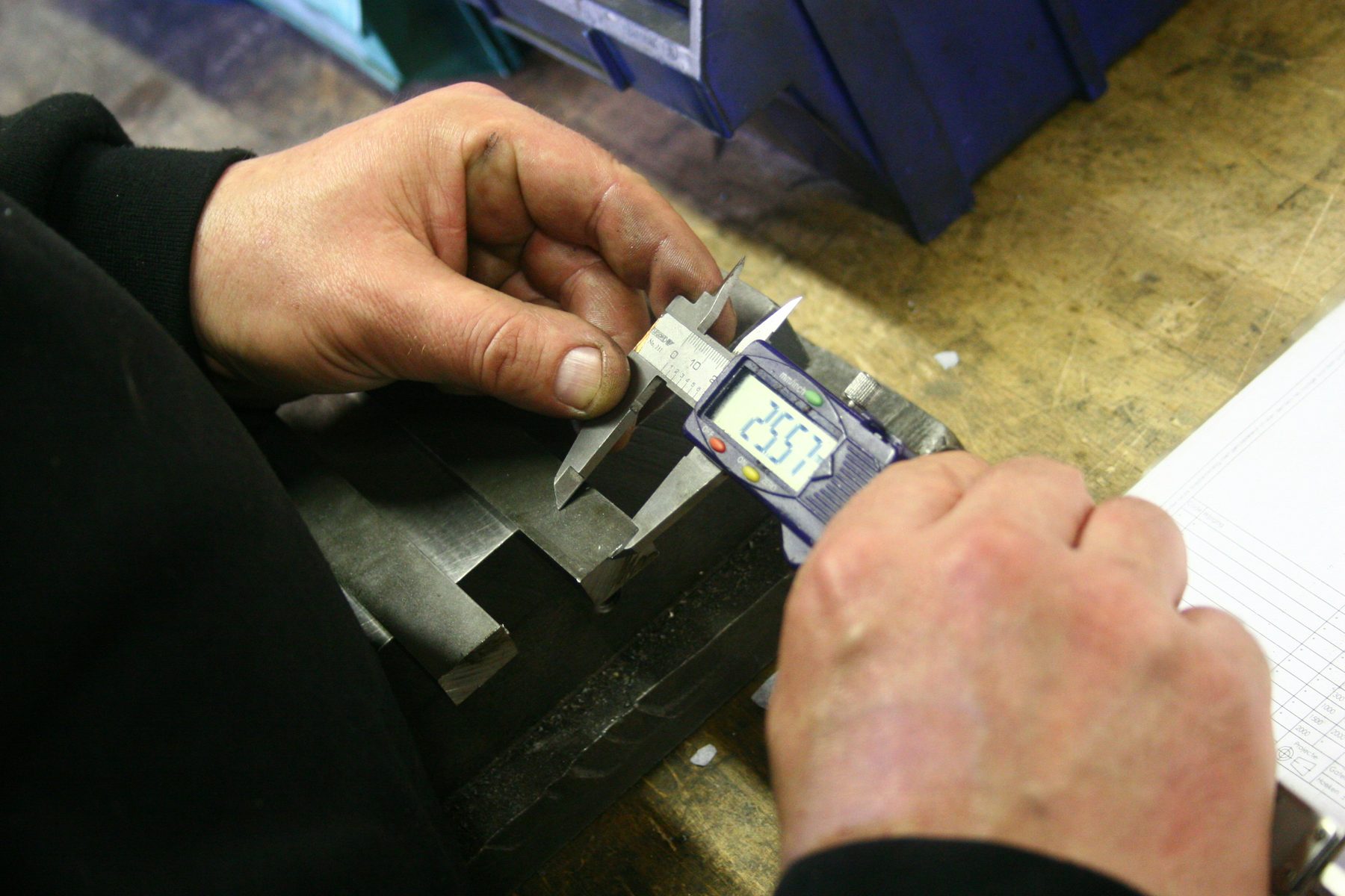 Quality inspector measuring an industrial component